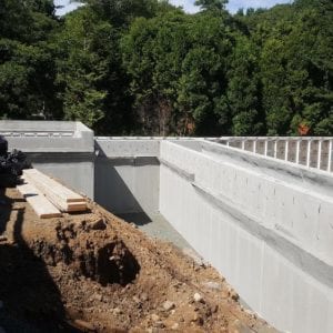 installing precast foundation for seaside home in Guilford, CT