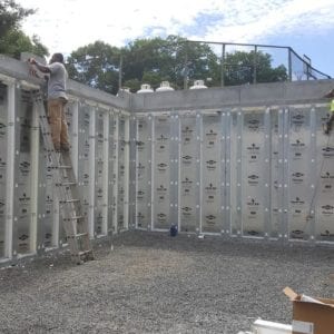 installing precast foundation for seaside home in Guilford, CT