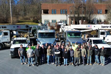 Weaver Superior Walls employees gathered in front of company fleet.
